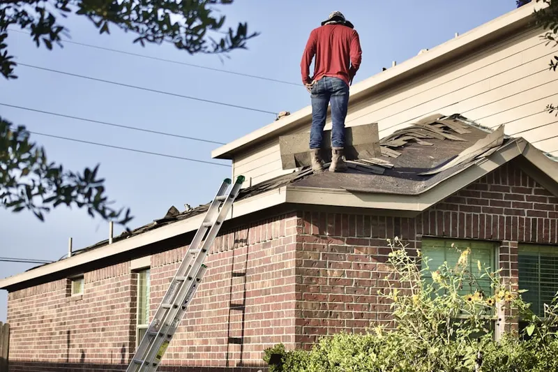 Professional roofer working on a residential roof in Gross Mill Estates